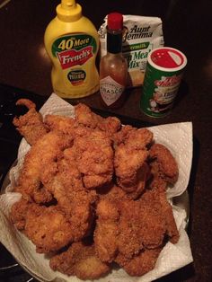 fried chicken on a plate next to mustard and ketchup