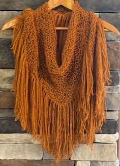 This unique Suri alpaca and wool triangle shawl was hand knit by Nancy at 2 Point Farm and features a long flowing fringe.  The autumn gold color makes it an eye catching accessory that adds a splash of color and interest to any outfit, dressy or casual.   It looks absolutely stunning with a black dress or all black outfit!  Wear the shawl wrapped loosely around your shoulder and tied in the front, or with the long fringe in the front (my favorite).  This particular shawl is LOADED with fringe.  The fringe is approximately 9 inches long and resembles the locks of a suri alpaca, and the fringe ends are not perfectly even just like the alpaca locks.   The scarf made from from a unique cabled yarn which is 75% Suri Alpaca and 25% High Luster Wool. The Suri Alpaca is a rare breed making up onl Knit Bandana, Boho Shawl, Triangle Shawl, Fringe Shawl, Yarn For Sale, Suri Alpaca, Triangle Shawls, Alpaca Fiber, Long Fringe