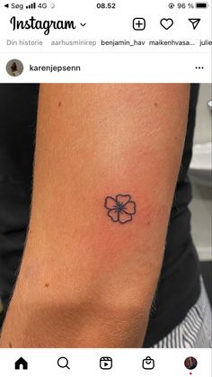 a small four leaf clover tattoo on the right arm and shoulder, with an instagram message below it