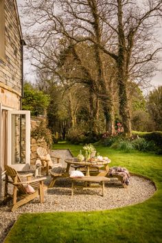 a patio with chairs and tables in the grass