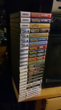 a stack of video games sitting on top of a wooden table