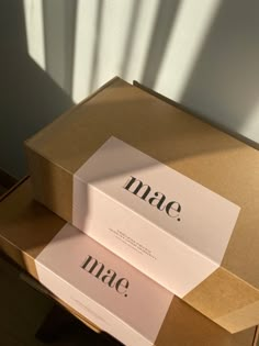 two boxes that are sitting on top of each other with the word mate printed on them