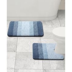 two bathroom rugs on the floor in front of a bathtub and toilet bowl