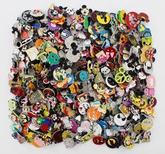 a pile of different kinds of buttons on a white surface