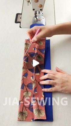 someone is using a sewing machine to sew something on a piece of fabric that has been folded