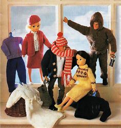 several dolls are posed in front of a window