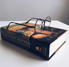 a harry potter book with glasses on top