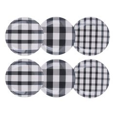 four black and white plaid plates sitting on top of each other in the shape of circles