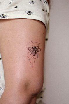 a woman with a bee tattoo on her thigh