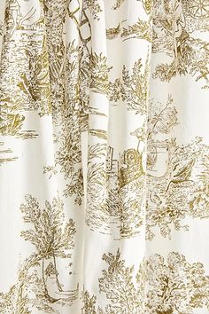 a close up view of a curtain with an image of trees and animals on it