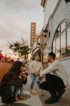 a group of people sitting on the side of a building