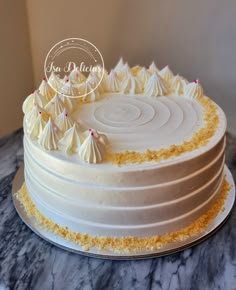 a white cake sitting on top of a marble counter