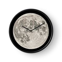 a clock with the moon on it's face is shown in front of a white background