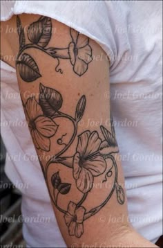 a woman's arm with flowers on it