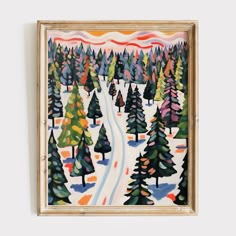 a painting hanging on the wall next to a wooden frame with trees painted on it