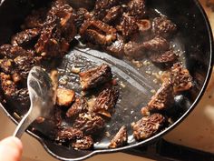 someone is frying some food in a skillet