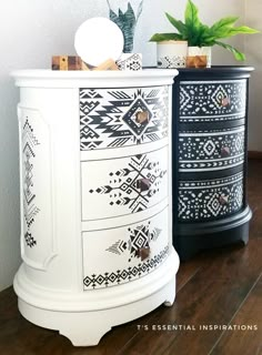 two black and white dressers sitting on top of a wooden floor next to each other