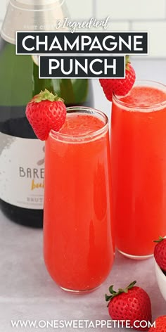 two glasses filled with champagne punch and strawberries on the table next to bottles of champagne