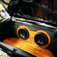 the inside of a car with speakers in it's trunk and an open hood