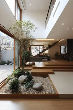 a living room filled with lots of furniture and plants