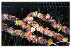 the skewers are being cooked on the grill