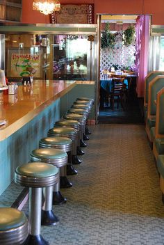 an empty diner with several stools at the bar