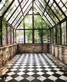 an instagramted photo of a room with lots of windows and black and white checkered floor