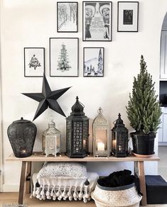 a table topped with lots of different types of lights and pictures hanging on the wall