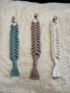 three crocheted tassels are sitting on a blanket