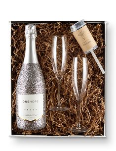 two champagne flutes and one bottle of wine in a box