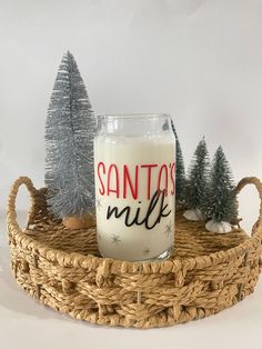 a glass with santa's milk sitting on top of a wicker basket