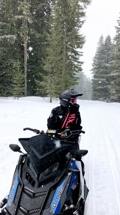 a man riding on the back of a snowmobile