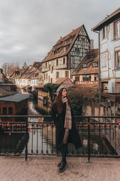 a woman standing in front of some buildings