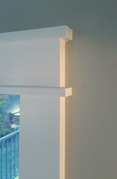 the corner of a room with white walls and blue railing