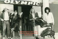 four people are standing in front of an olympic store