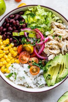 a bowl filled with rice, beans, avocado, tomatoes and other vegetables