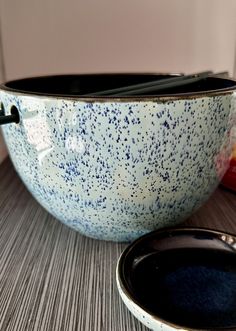 two bowls with spoons in them sitting on a table