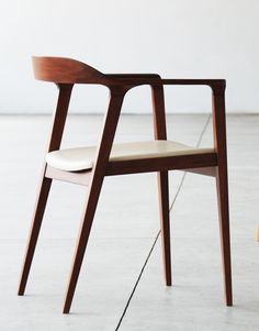 a wooden chair sitting on top of a white floor