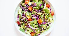 a white bowl filled with salad on top of a table