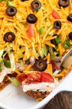 a casserole dish filled with meat, cheese and vegetables