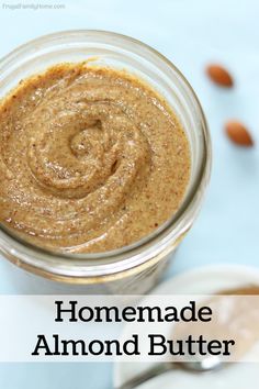 homemade almond butter in a glass jar with the words homemade almond butter above it and an image of almonds