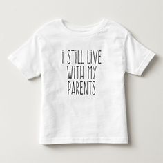 Your little one will look so cute wearing this! This unique design features a simple font that reads, "I STILL LIVE WITH MY PARENTS". It's a cute and charming design! Furthermore, this product will make an adorable baby shower gift for a friend who is expecting! It's safe to say that no one else will have purchased a product like this, as this is a unique design. If you prefer to have personalized text on your product, click the "Customize It" button, and Zazzle will easily allow you to do that. Kid Sayings, Cricket Store, Babies Fashion, Shirts Vinyl, Htv Projects, Funny Toddler Shirt, Funny Kids Shirts, Toddler Humor, Cricut Designs