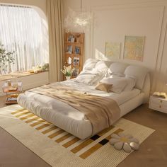 a large white bed sitting on top of a wooden floor next to a tall window