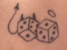 a tattoo with dices on it and an arrow in the middle that is flying through the air