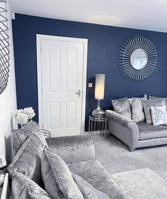 a living room with blue walls and white furniture in the corner, is featured on instagram