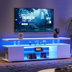 the entertainment center is lit up with blue lights and features a large flat screen tv