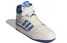 If you're looking for a sneaker that's both retro and modern, the Adidas Forum 84 Hi OG 'Bright Blue' is the perfect choice. This updated take on a classic hoops shoe features faded blue accents and pre-yellowed detailing for a vintage look. The white leather upper is secured with traditional laces and an adjustable hook and loop ankle strap, while the EVA wedge on the medial-side midsole is distinguished by Dillinger webbing. The blue rubber outsole is complete with a contrasting red pivot poin Adidas High Tops, Adidas High, White Sneakers Men, Adidas Forum, Adidas Trefoil, Adidas Sneaker, Star Lord, Marvel X, Swag Shoes