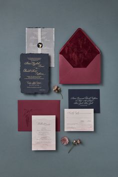 the wedding stationery is laid out on top of each other, including an envelope and two