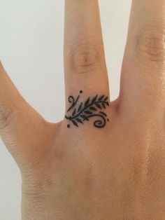 a hand with a small tattoo on it