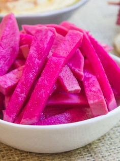 a white bowl filled with sliced up radishes